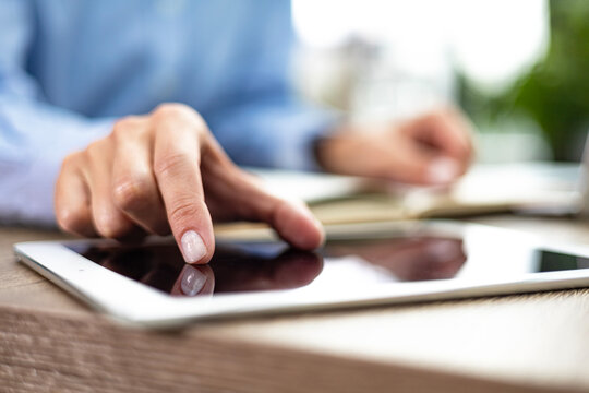 Midsection of businessman using digital tablet in office.