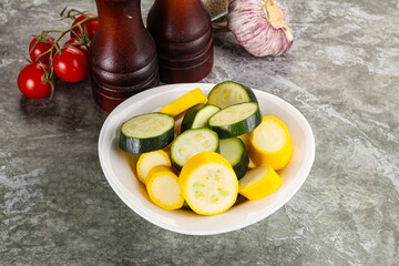 Sliced raw young green and yellow zucchini