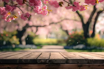 Fotobehang Empty wooden table in Sakura flower Park with garden bokeh background with a country outdoor theme, Template mock up for display of product © kardaska