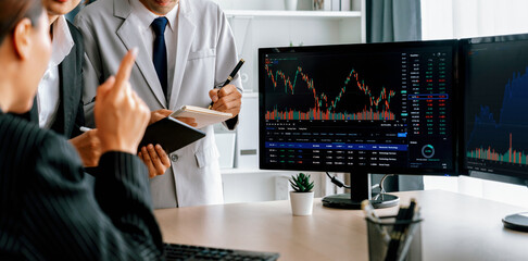 Professional broker present interested stock with growth graph to skilled businesswoman for...