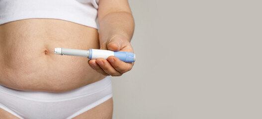 Female model holding opened blue Semaglutide Injection pen or insulin cartridge pen. Weight loss...