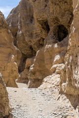 punched steep worn sandstone cliffs at narrow Serisem canyon, Naukluft desert,  Namibia