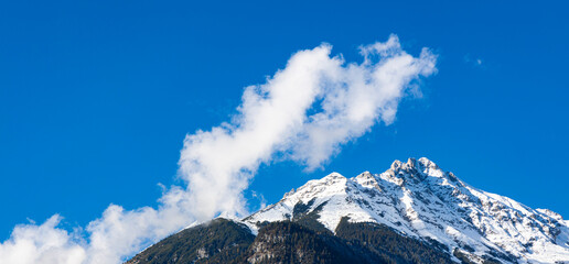 The banner mountain view of alpine as snow-capped mount peaks scene  in Winter mountains background