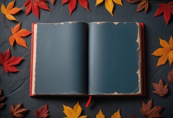 blue slate background, with red autumn leaves and an open book, providing copy space - obrazy, fototapety, plakaty
