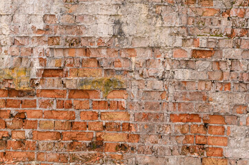 The red brick wall is crumbling. brick background