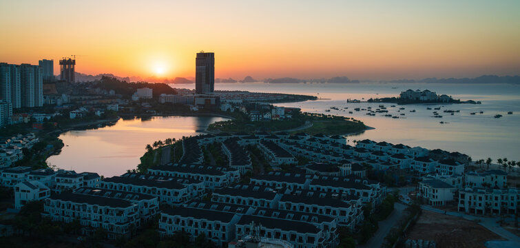 Sunrise with view over the landscaped islands with construction sites in Halong City, Vietnam