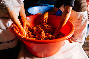 Crop women mixing minced meat while making homemade sausages
