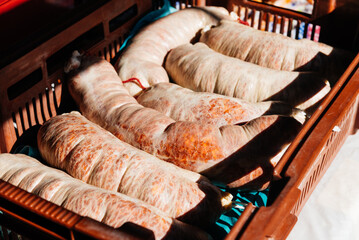 Collection of freshly cooked linked sausage meat in basket