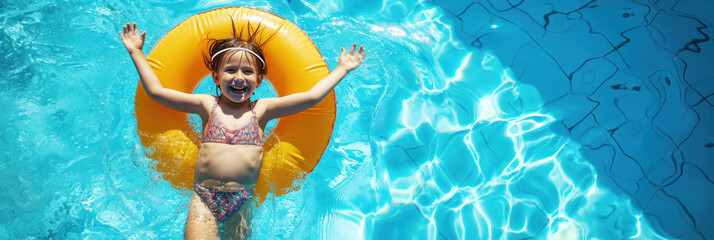 A happy smiling girl in a bright swimsuit swimming on inflatable ring at pool. 
