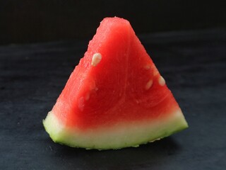 Sliced ​​watermelon fruit contains a lot of water and sweet taste.isolated on black background.