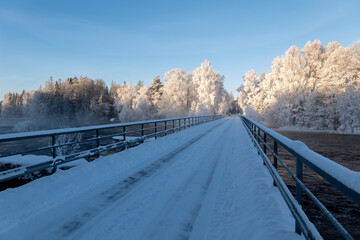 Country road landscape in a cold and frosty winter day - 716403230