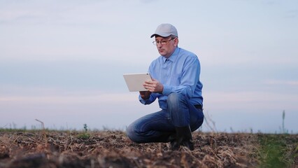 farmer looks soil field, farms, agronomist works unpaved soil, plowed soil field, farmer works hand digital tablet, hand, together, quality, agronomist, industrial, food, outdoor, control