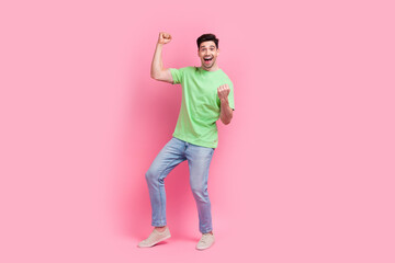 Full length body photo of young successful man wear green t shirt just promoted to senior manager isolated on pink color background