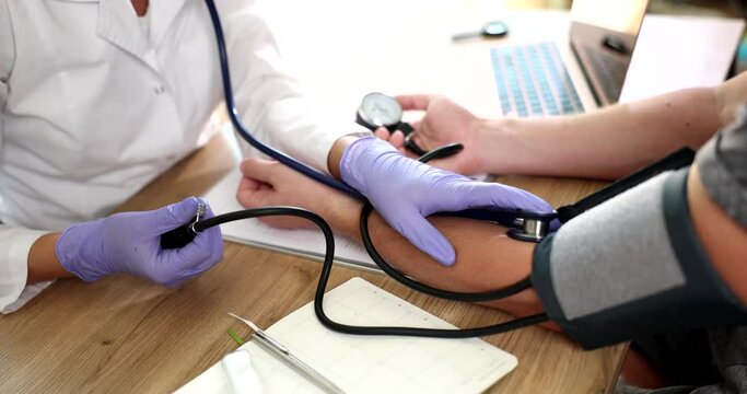 Therapist uses blood pressure monitor to check body pressure and pulse of patients. Blood pressure control
