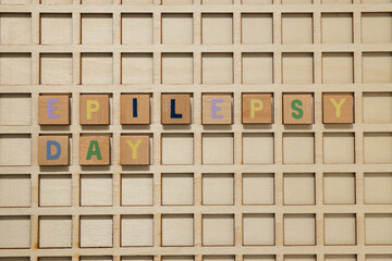 Inscription Epilepsy Day in wooden letters on a wooden background