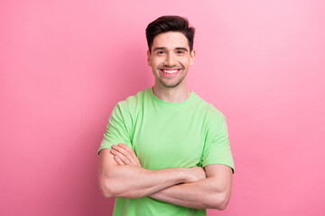 Portrait of handsome businessman folded arms wearing casual green t shirt without dress code in...