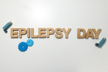 Epilepsy day written in wooden letters with inhalers