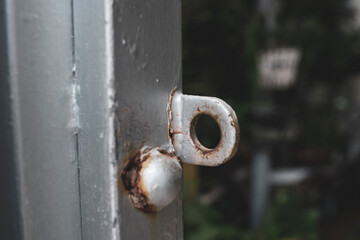 From above of round robotic vacuum cleaner sliding on light laminate floor and removing dirt spilled out of glass pot.