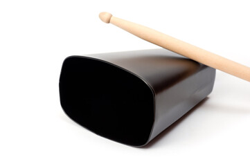 Cowbell percussion musical instrument, black metal with a wooden stick.
