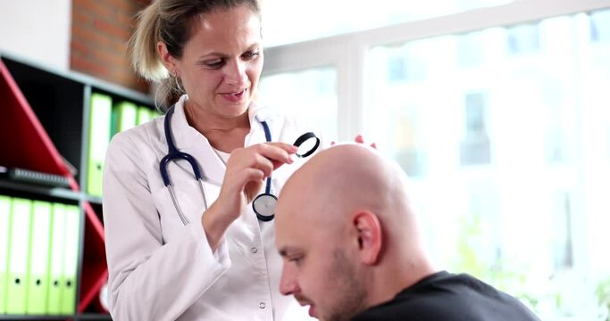 Trichologist examines hair of man suffering from alopecia. Hair loss and alopecia in man