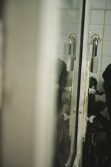 From above of round robotic vacuum cleaner sliding on light laminate floor and removing dirt spilled out of glass pot.