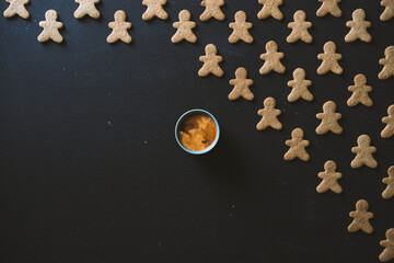 Coffee with gingerbread man cookies on blackboard table top