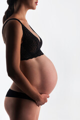 Fototapeta premium Young pregnant woman in studio
