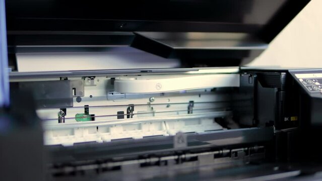 Laser printer operation. Closeup of paper printing.