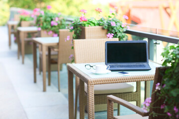 Laptop, smartphone, glasses and coffee on the table