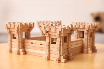 Wooden fortress on table indoors, closeup. Children's toy