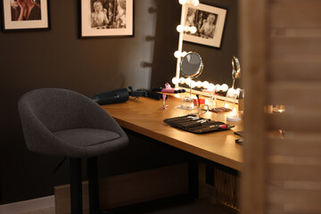 Makeup room. Stylish mirror on dressing table with different beauty products