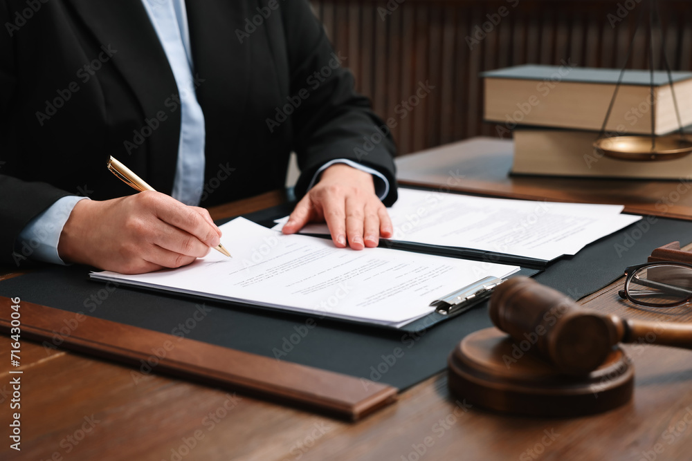 Sticker Lawyer working with documents at wooden table indoors, closeup