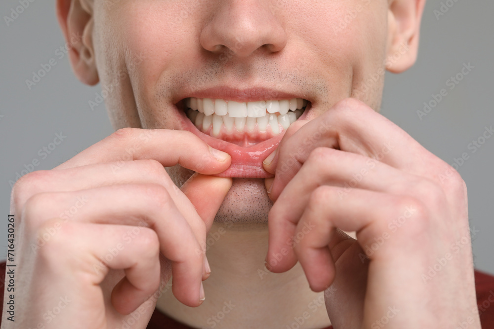 Canvas Prints Man showing his clean teeth on light grey background, closeup