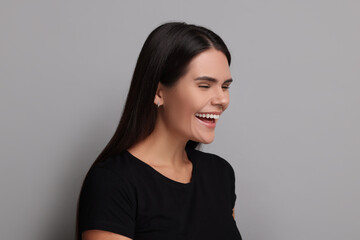 Fototapeta premium Personality concept. Emotional woman on grey background