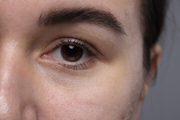 Fototapeta premium Closeup view of woman with beautiful eyes on grey background