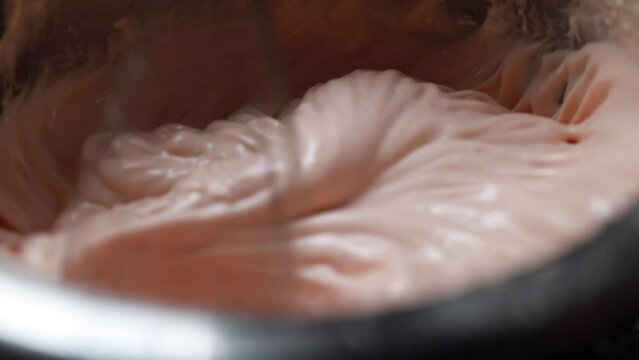 Whip up a delicious pink cream with a mixer. This is a step-by-step preparation of the cream for the cake