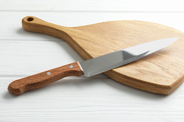 One sharp knife on white wooden table, closeup