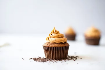 Foto op Plexiglas chocolate buttermilk frosting spread on cupcake, close-up © primopiano