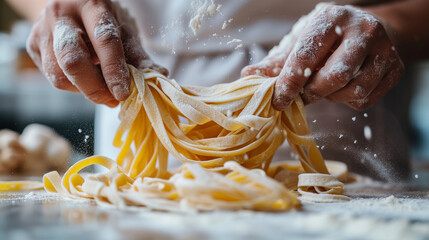 Close up hands making fresh italian pasta on white kitchen background
