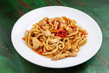 Wok noodles, noodles with chicken, carrots and peppers in teriyaki sauce.