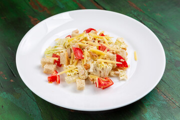 Classic Caesar salad with tomato, cheese, croutons, chicken and lettuce.