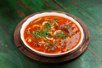 Red soup with meat and noodles.