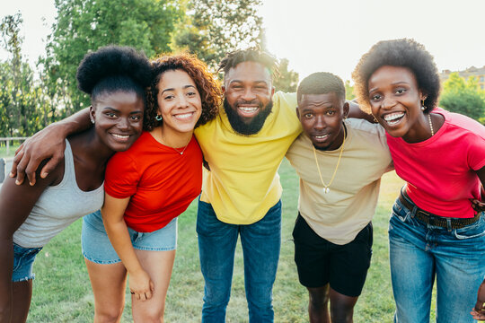 Young Happy Smiling Multiracial Group Of People Posing Together Outdoors - Lifestyle Concept With Guys And Girls Having Fun Hanging Out On Park