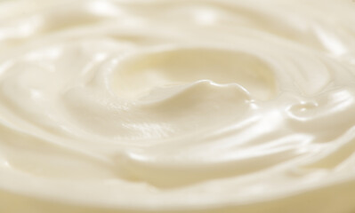 Sour cream or greek yogurt swirl texture, White cream background, close up. Dairy product. Delicious organic creamy yogurt. Milk cream