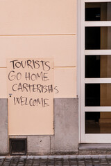 Barcelona, Spain - August 16, 2022: Protest graffiti against invasive tourism, in the Gracia...