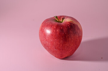 red apple on a pink background 1