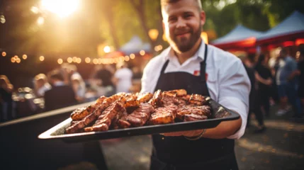 Foto op Plexiglas Waiter or chef holding a tray with grilled meat or fried ribs on a beautiful background. © muhammadjunaidkharal
