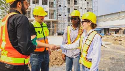 Teamwork handshake cooperation of architects and male and female workers multiethnicon on the...