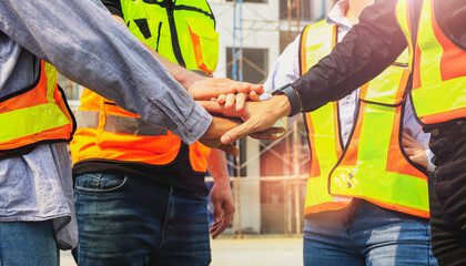 Team multi-ethnic workers, men and women, join hands to join forces to join forces to work for the industry for success. Teamwork and professional colleagues : Workers' hands, teamwork concept.