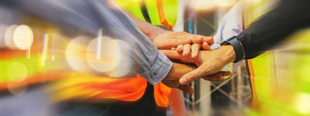 Team multi-ethnic workers, men and women, join hands to join forces to join forces to work for the industry for success. Teamwork and professional colleagues : Workers' hands, teamwork concept.